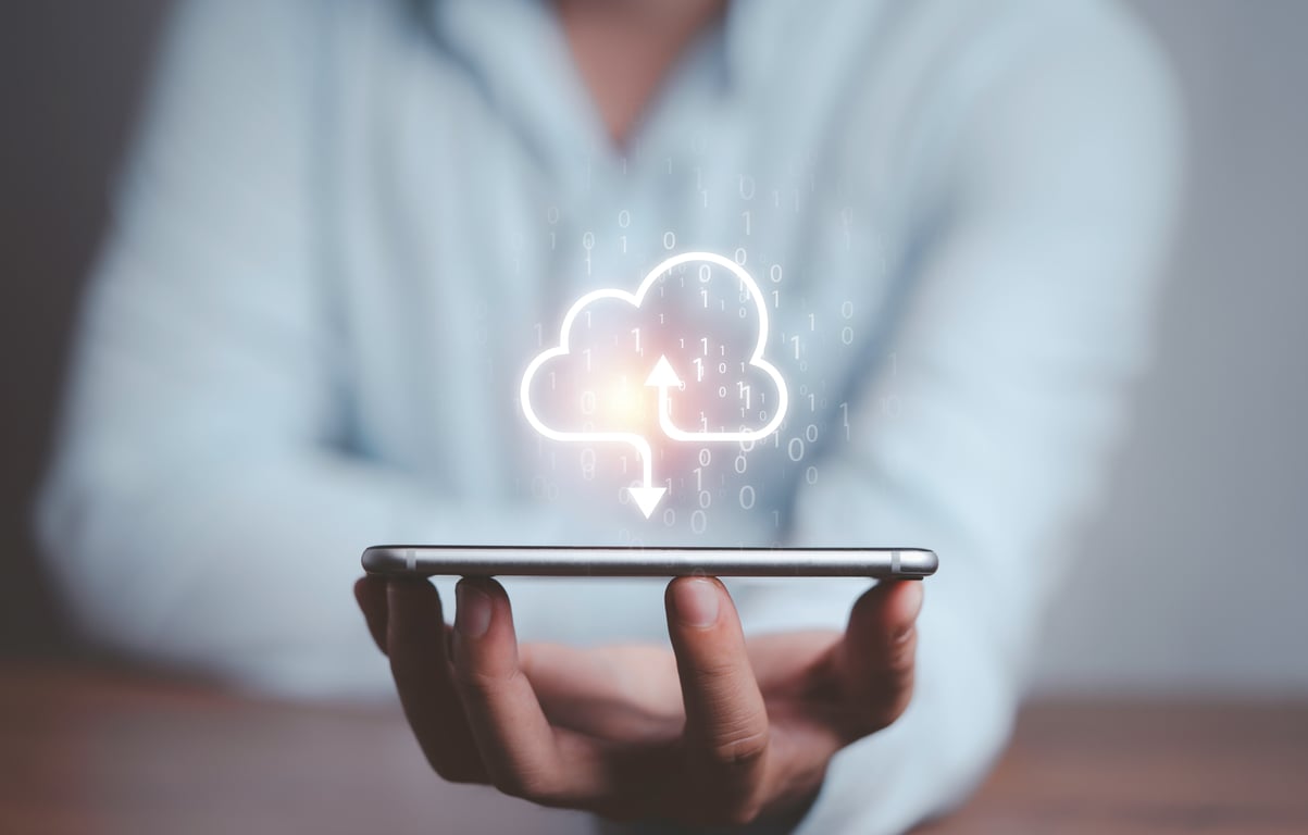 A man holds a phone above him with a cloud of information