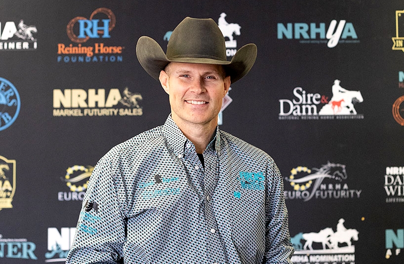 Jason Vanlandingham at an NRHA event — portrait in front of sponsor backdrop