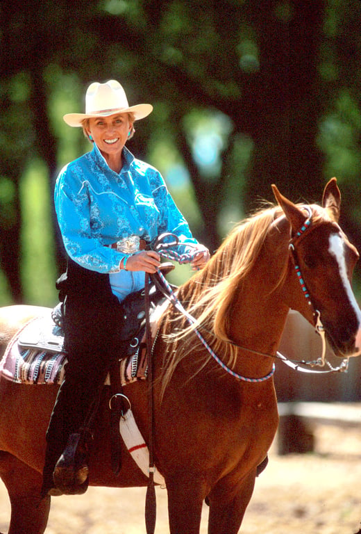 Linda Tellington-Jones riding a chestnut horse — western horsemanship
