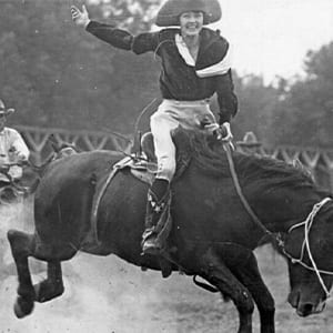 Mabel Strickland Woodward riding a bucking bronc — early twentieth century rodeo