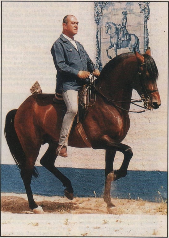 Nuno Oliveira riding a bay horse in front of Portuguese azulejo tile work — classical dressage master