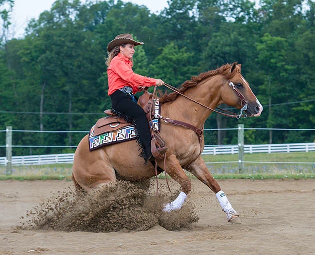 Stacy Westfall executing a sliding stop in reining competition