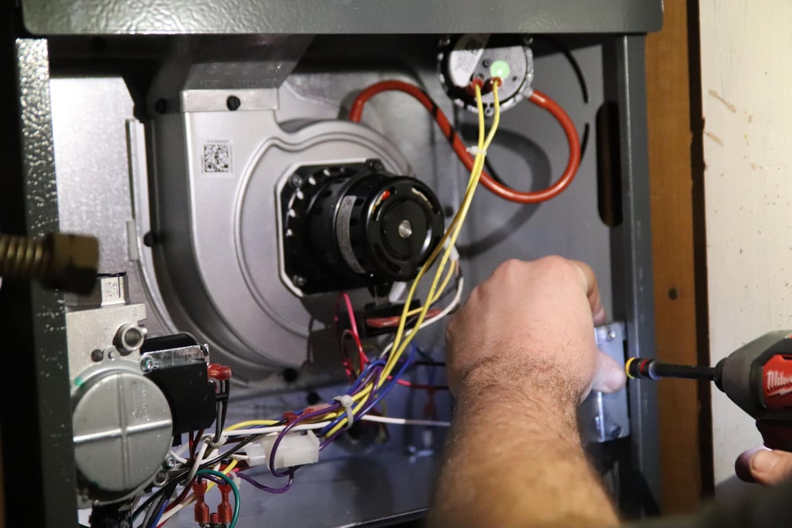 Technician diagnosing a residential air conditioner