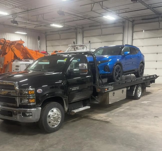 Tow truck transporting a vehicle safely