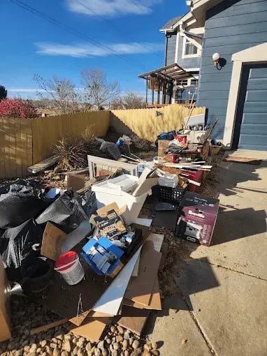 86IT! junk removal crew loading a truck in Loveland, CO