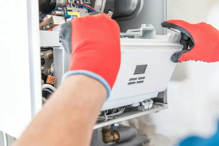 Technician inspecting a residential furnace
