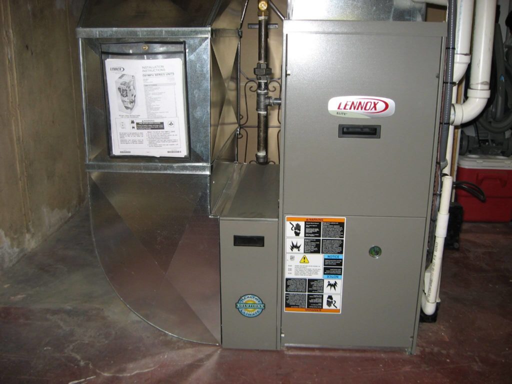 Technician inspecting a residential furnace