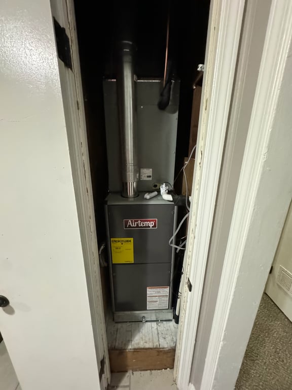 Technician diagnosing a residential air conditioner