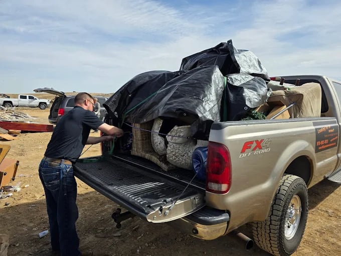 86IT! junk removal crew loading a truck in Loveland, CO