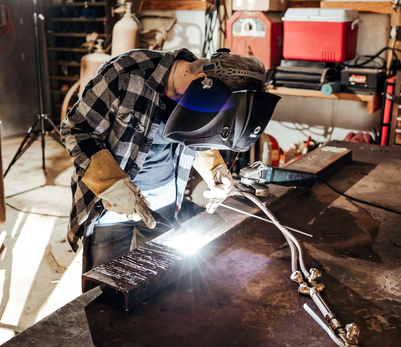 Fabricator welding at the bench