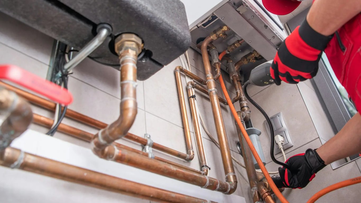 Technician repairing residential plumbing