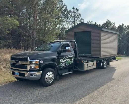 Gordon's Towing hauling a shed