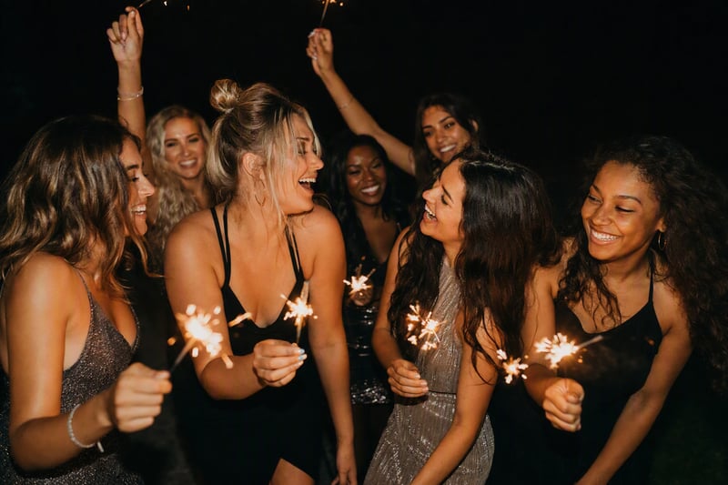 Friends holding sparklers at midnight, shot with flash so the confetti freezes mid-air