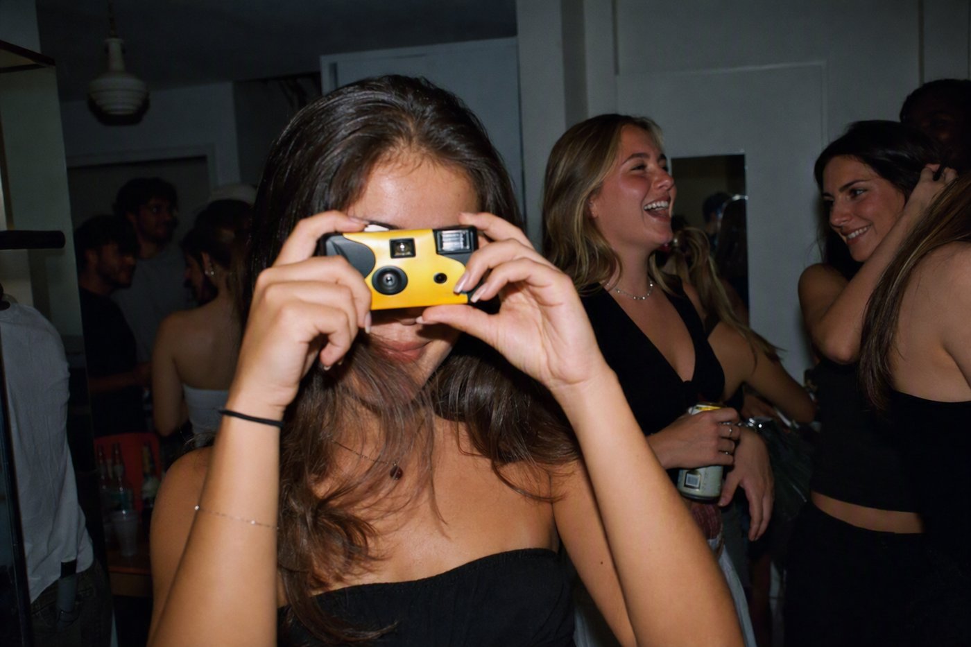 The disposable-camera moment the apps are chasing: hard flash, friends squeezed in, no second take