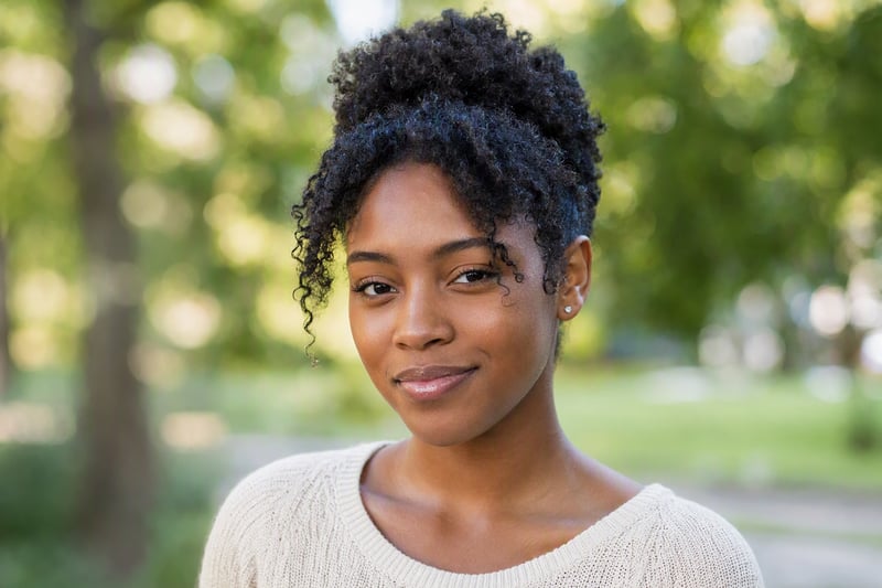 Portrait with a softly blurred street background behind a sharply focused face