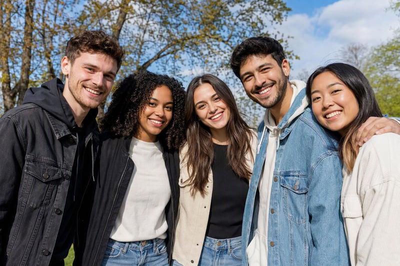 A group of six friends posing outdoors, one person mid-blink in the frame