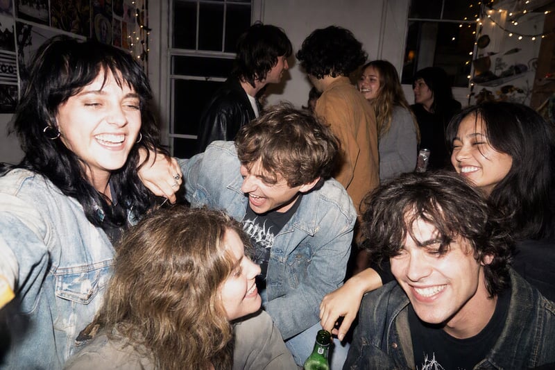 Crowded party photographed with harsh direct flash, blown highlights and tilted frame