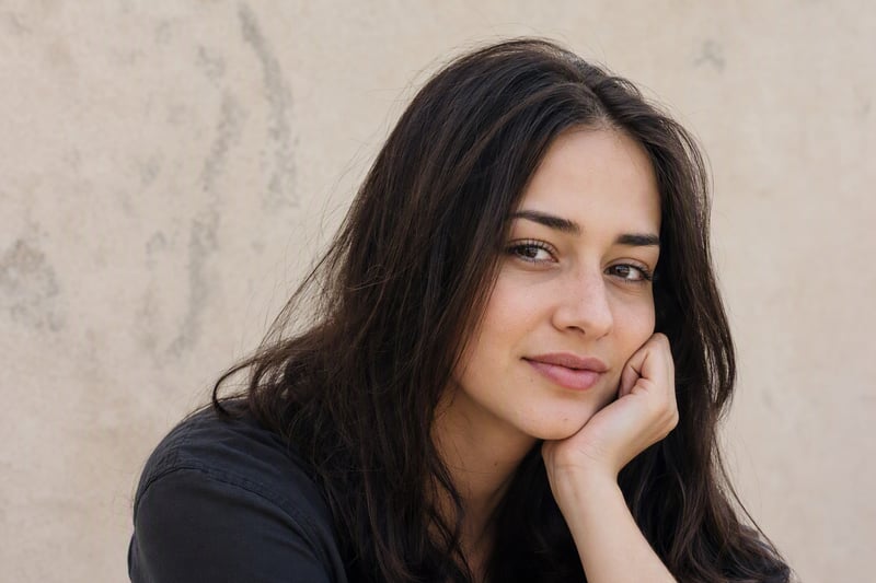 Close portrait in daylight with visible skin texture and one small healed mark