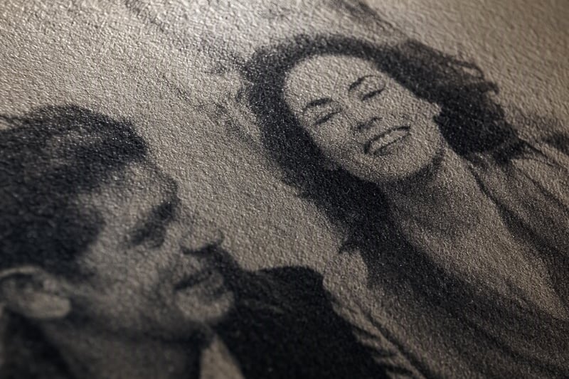 Close crop of a portrait showing fine film grain across the skin and background