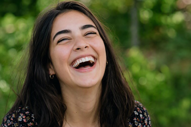 Relaxed smile in daylight with teeth that read naturally bright rather than pure white