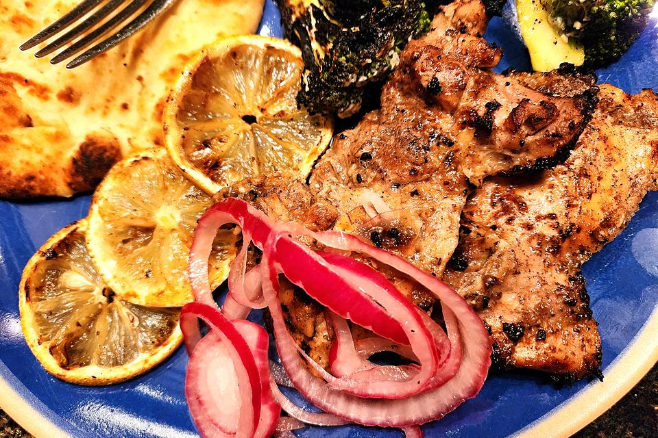 Grilled chicken thighs w/sumac, pickled onions,