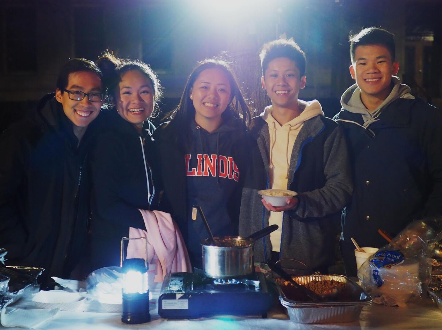 TASC Night Market 2020 booth showing volunteers serving food.