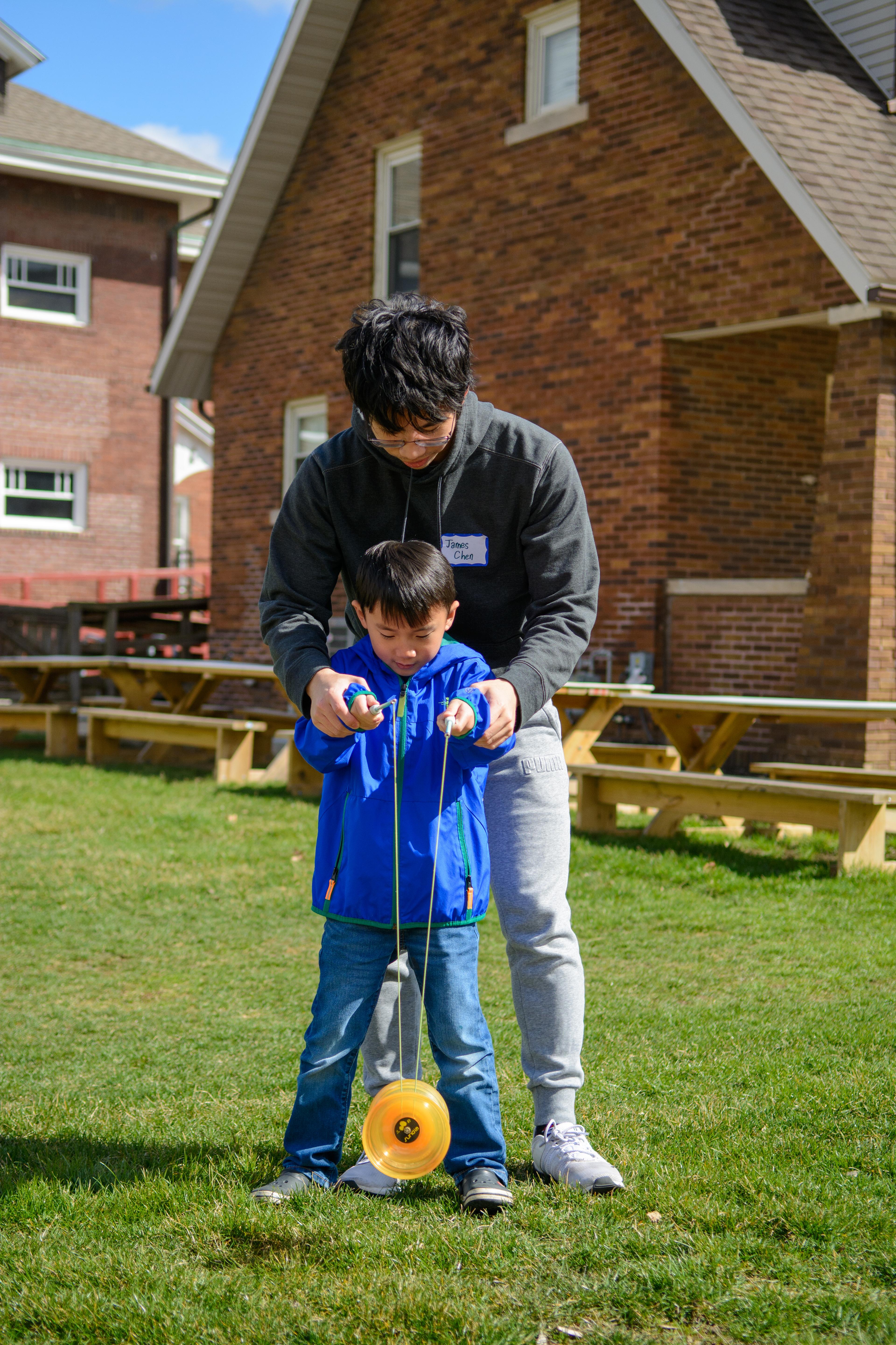 TASC member teaching an adoptee Chinese yo-yo at ICASP 2023