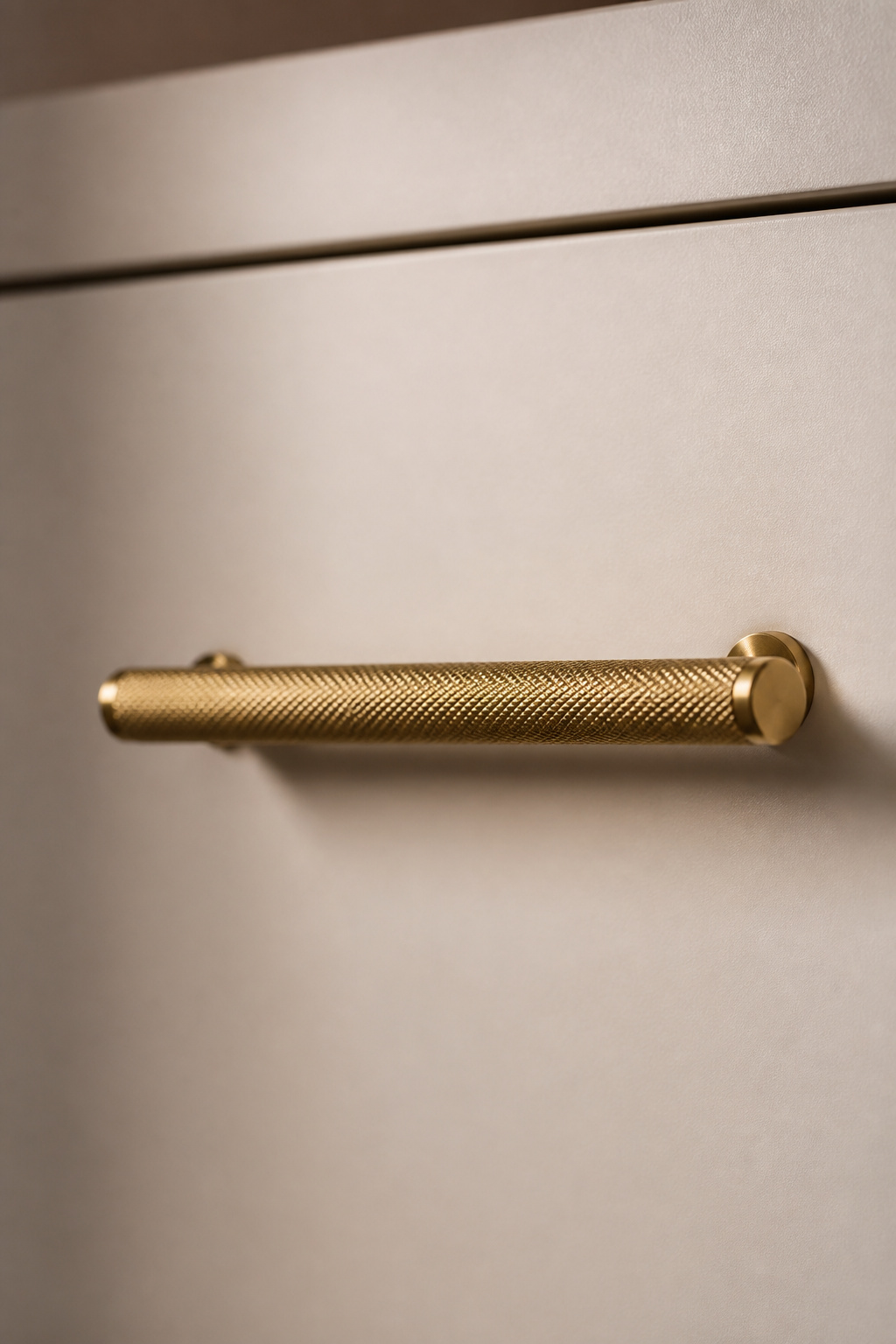 A single knurled brass bar handle — 200mm, mounted consistently on every door — demonstrates that one considered hardware choice, used throughout, reads more resolved than any variety of options.