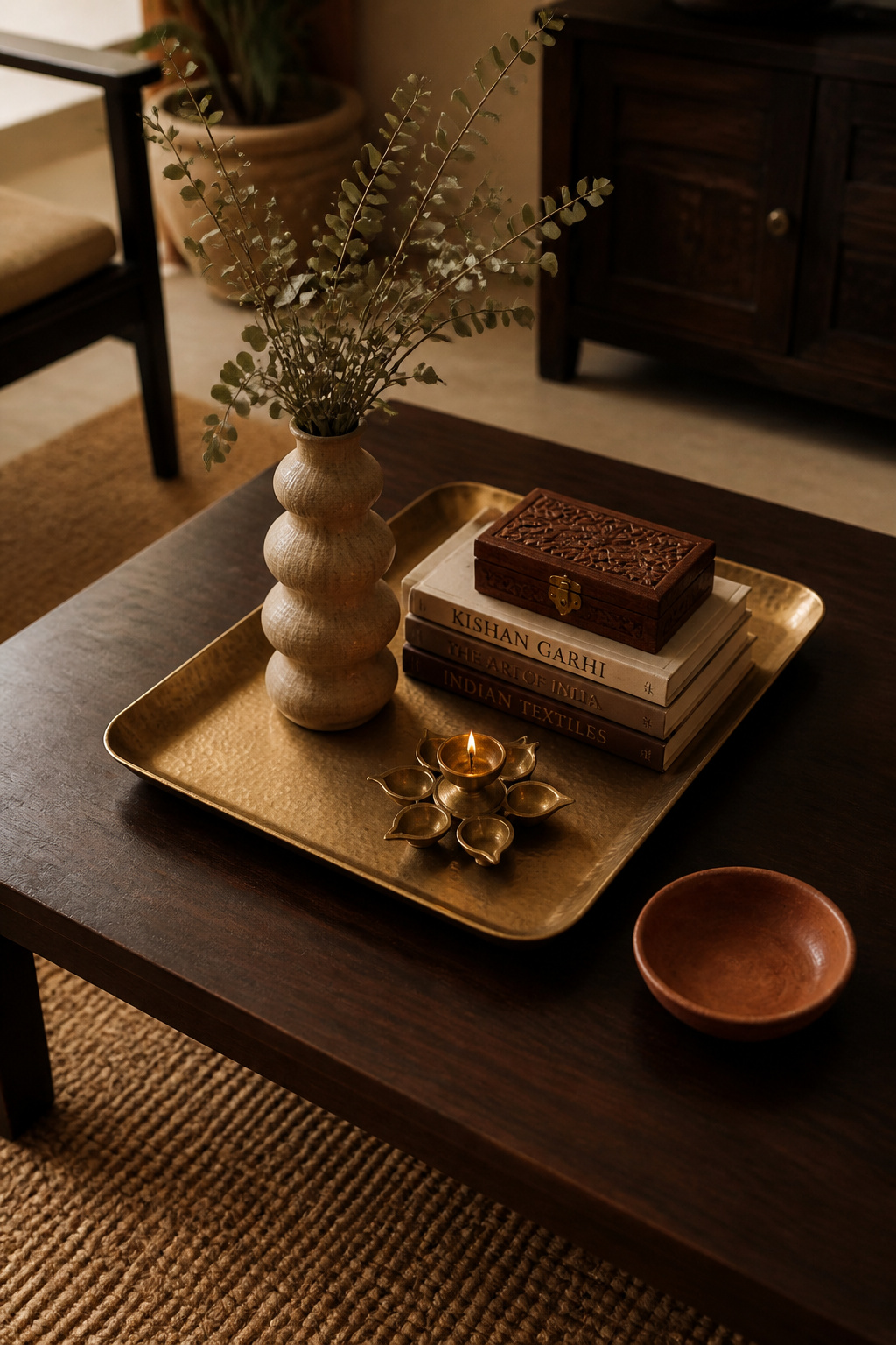 The tray is what separates a styled coffee table from an occupied one — it creates visual boundaries, keeps the arrangement portable, and makes restyling a matter of seconds.