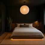 The complete black bedroom as sanctuary — matte accent wall, low walnut platform bed, warm pendant lighting, and organic accents that prevent the dark palette from reading as anything other than intentional.
