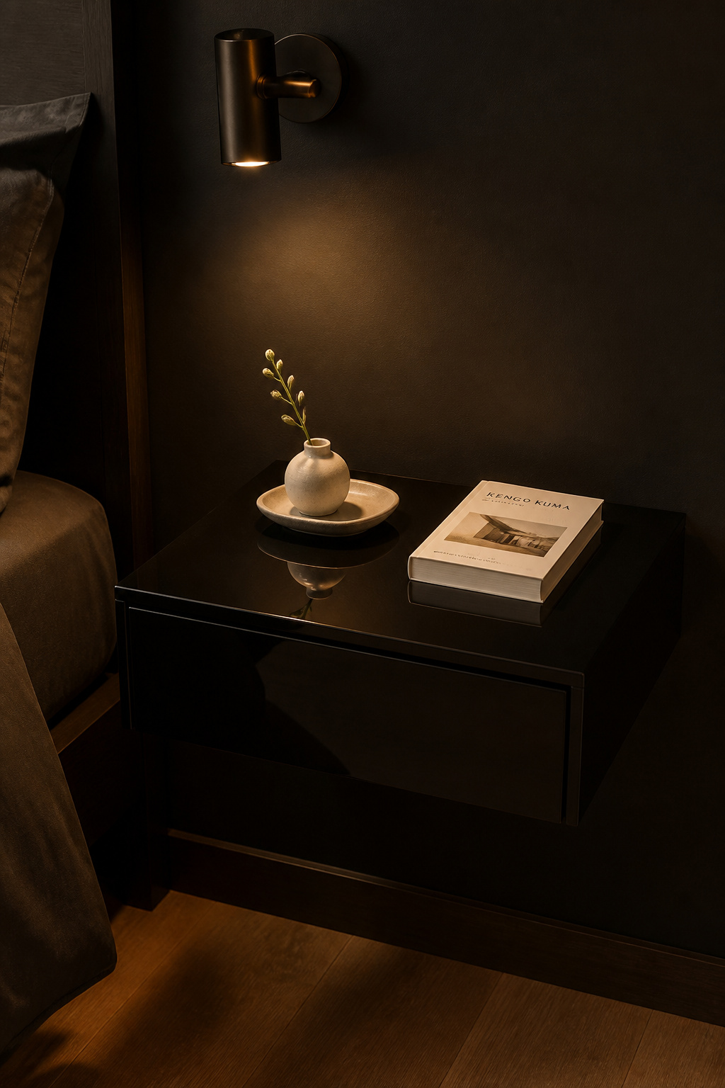 A high-gloss lacquer nightstand against a matte black wall uses the same hue at opposite reflectance levels — the most refined surface contrast in black bedroom decor.