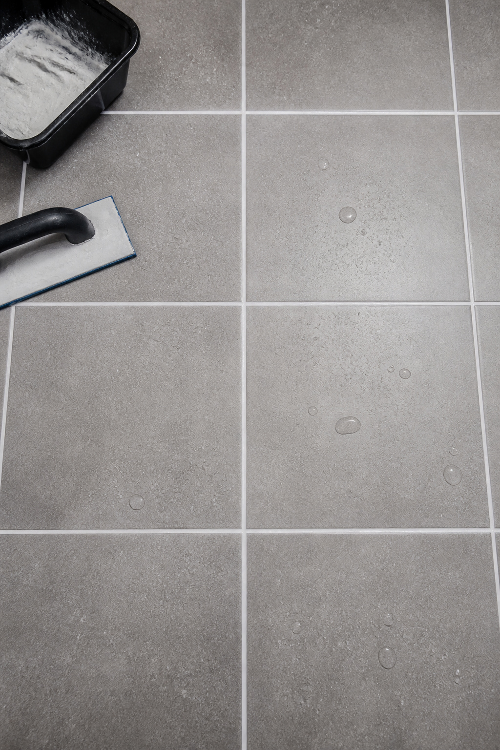 Fresh epoxy grout restores the visual calm of a tiled floor without a single tile replaced — one of the most durable bathroom ideas on a budget for a floor that sees daily wet use.