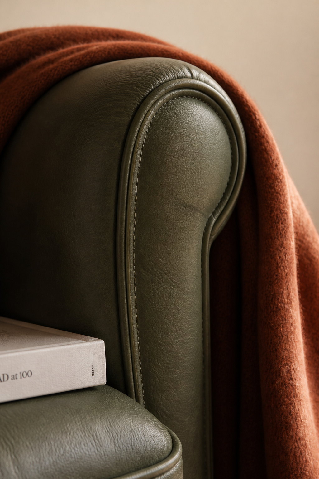 The sofa's quality is written in its stitching and leather grain — details that reveal themselves over years of daily use rather than disappearing into them.