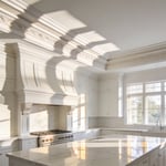A bright luxury kitchen with white cabinetry and intricate multi-piece crown molding casting deep shadow lines.