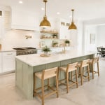 A complete white kitchen remodel with sage green island, Calacatta quartz countertops, subway tile backsplash, and warm wood accents — the full design picture in one composed image.
