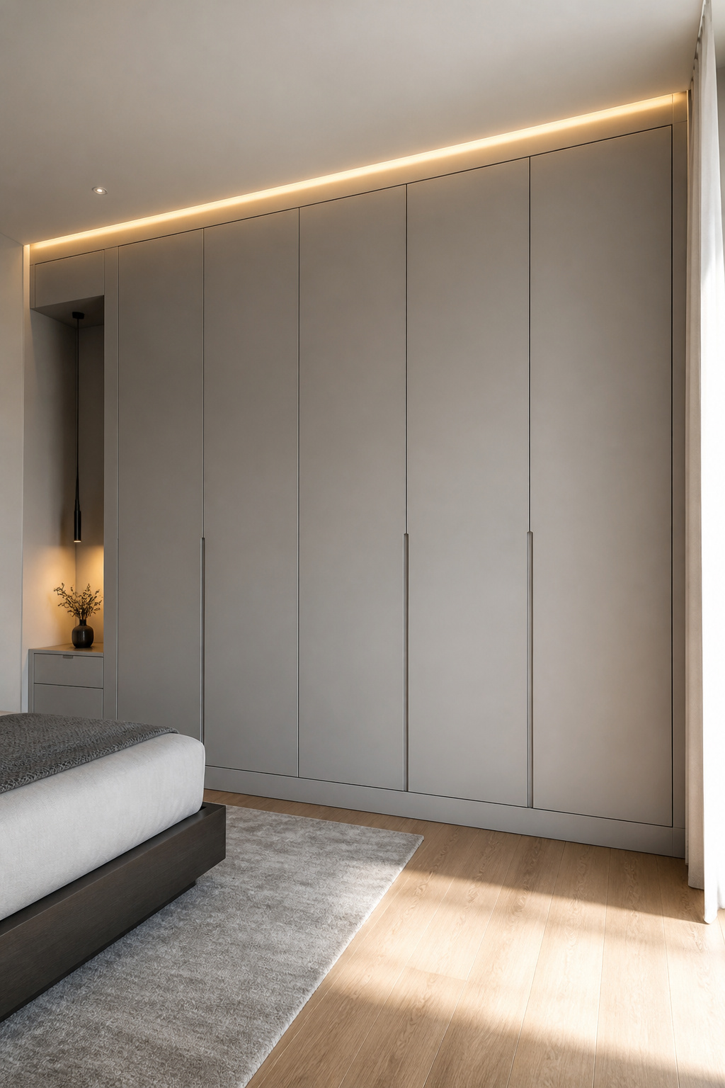 Floor-to-ceiling millwork with precise 12mm shadow gaps and inset doors integrates storage into the architecture rather than placing it in front of it.