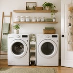 A well-organized laundry room with floating shelves, door storage, and a rolling cart proves that smart laundry room organizers can transform even the smallest space into one that actually works.
