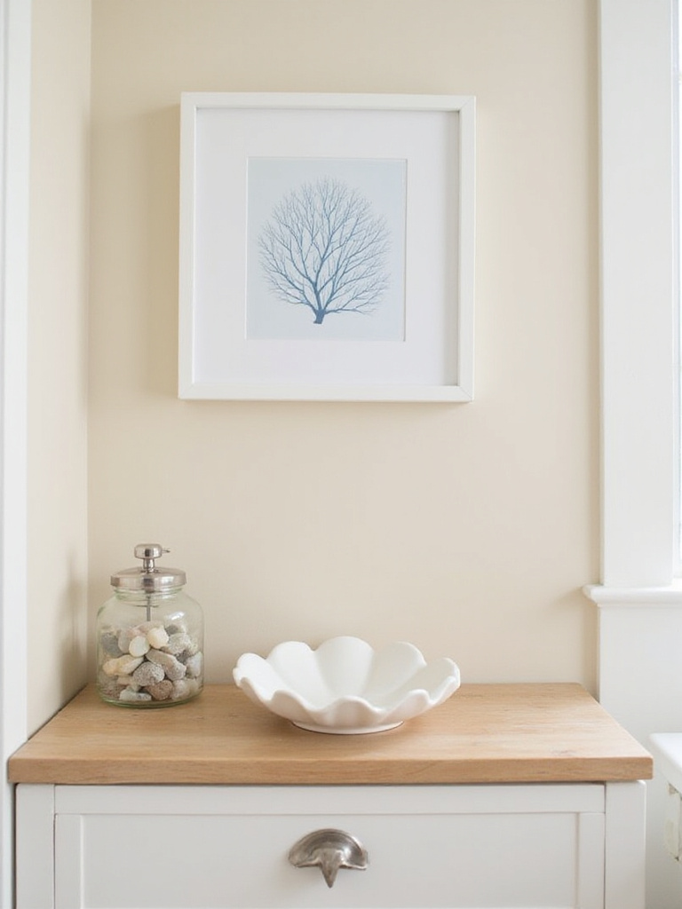 Coastal bathroom vanity with shell soap dish, sea glass jar, and framed coral print.