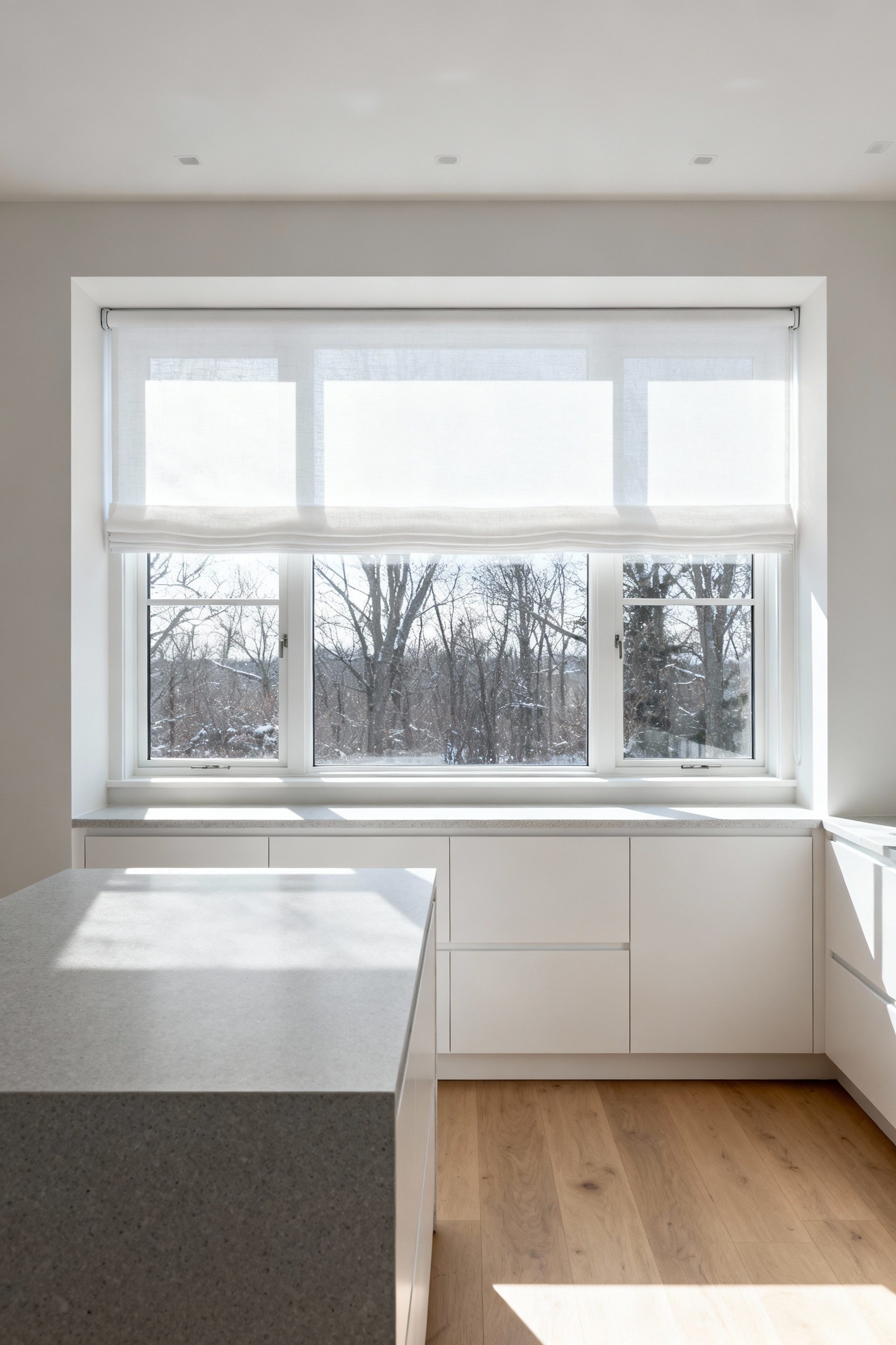 Bright kitchen featuring sheer white roller shades mounted outside the window trim to maximize the exposed glass area and allow maximum natural light entry.