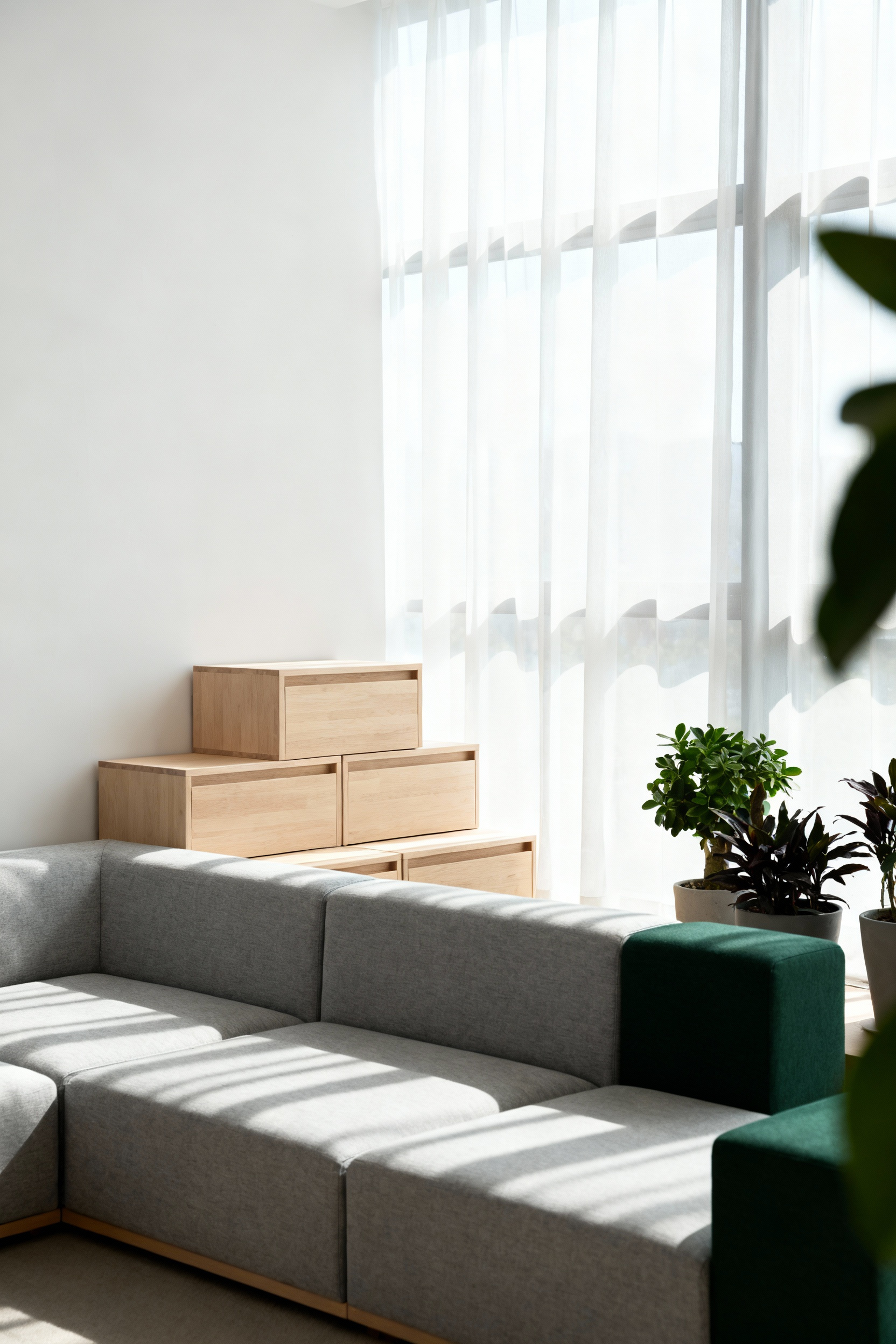 A professionally staged Scandinavian living room with a grey modular sofa configured for adaptive use, featuring light wood storage and natural lighting, embodying modular versatility in design.