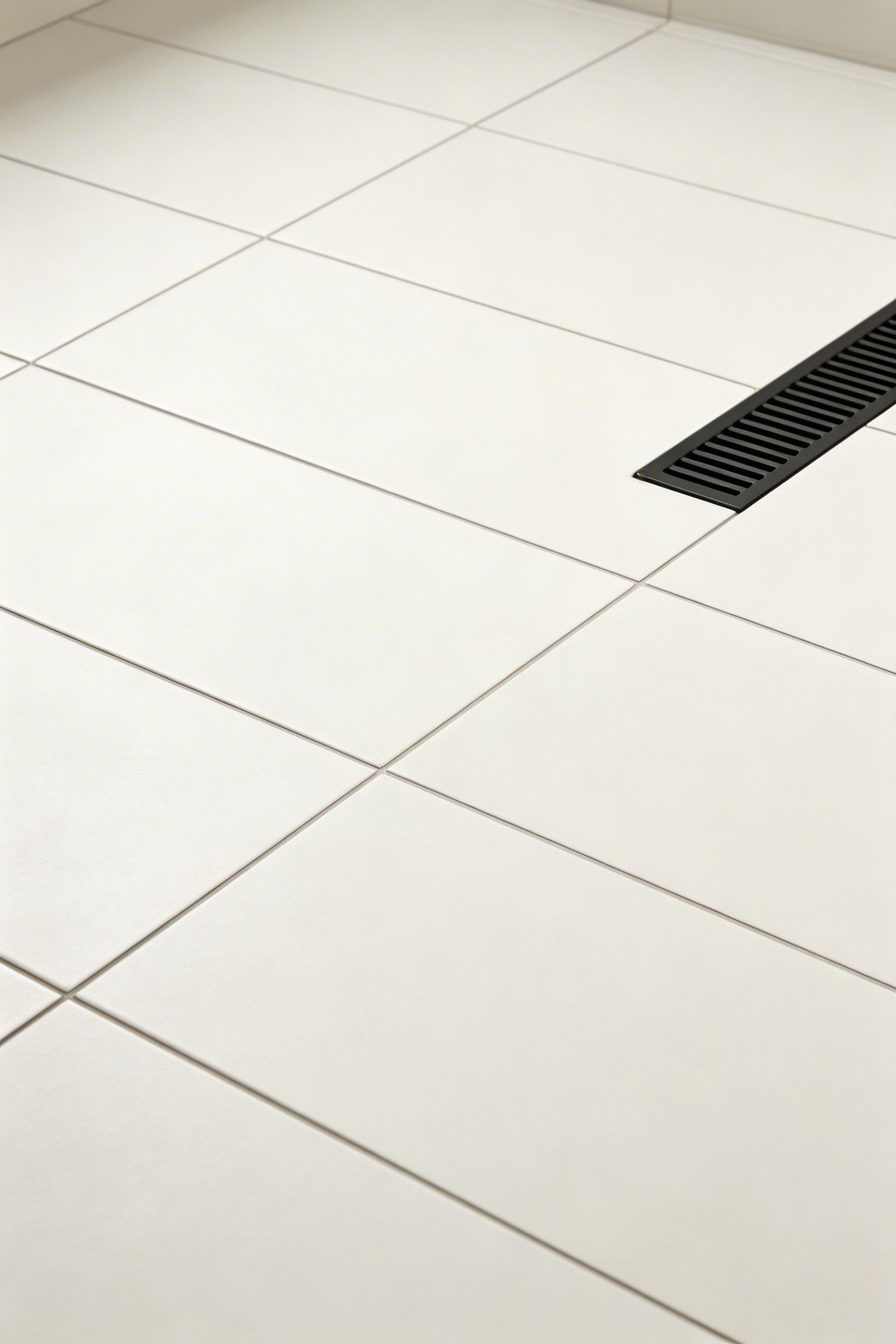 Large-format 24x48 porcelain tile with tight grout lines is a core element of contemporary bathroom remodel design, expanding the visual floor plane significantly.