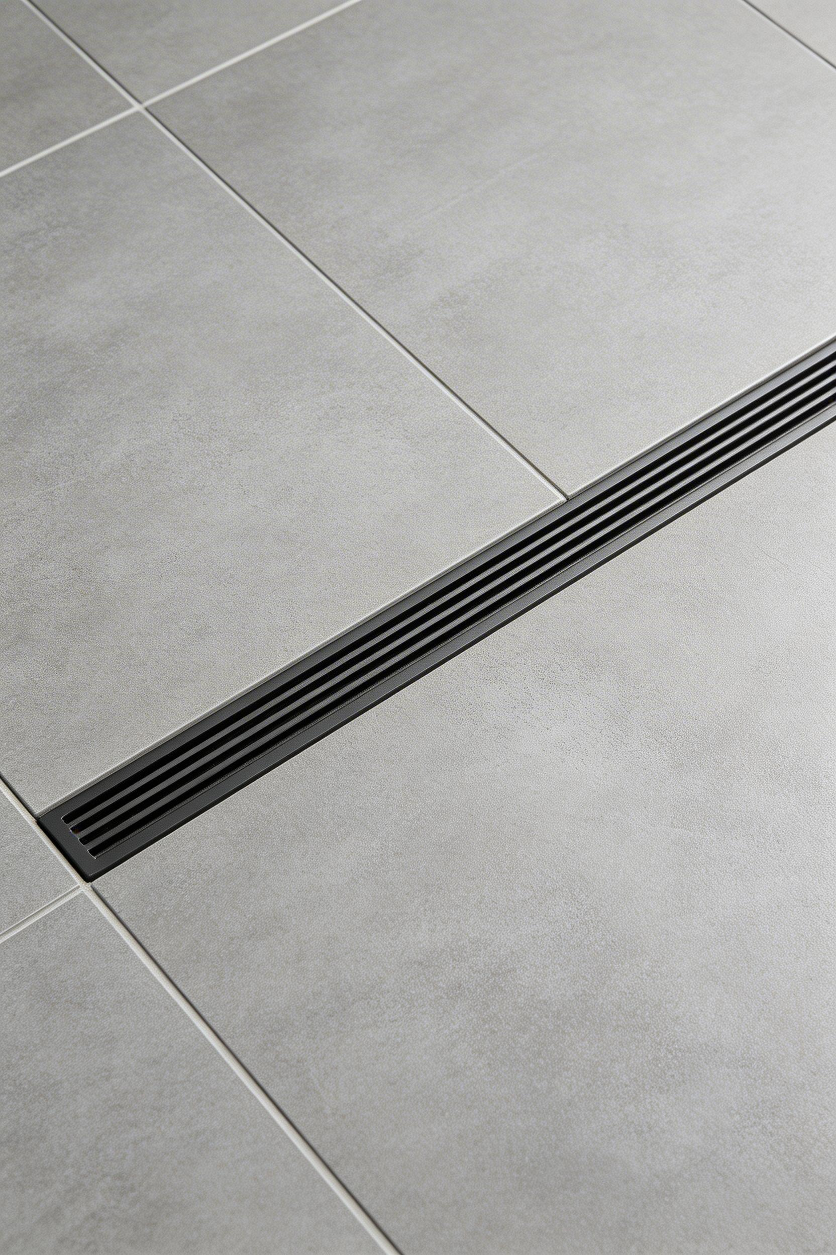 A linear drain allows large-format tile to flow uninterrupted across the shower floor — the detail that separates a considered contemporary bathroom remodel from a surface-level refresh.