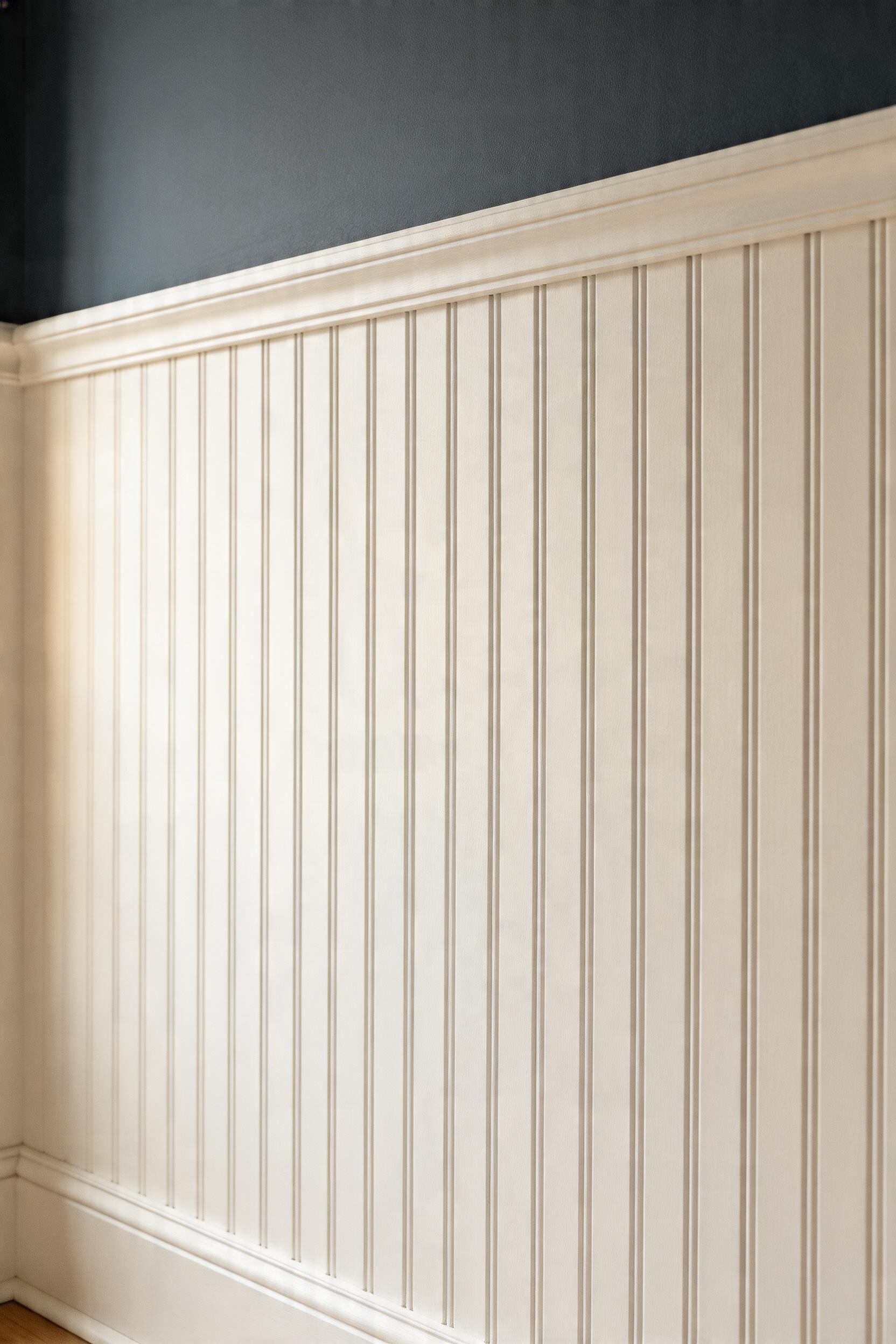 Beadboard wainscoting in traditional white finish with dark upper walls, demonstrating how horizontal division adds architectural interest and heritage character.