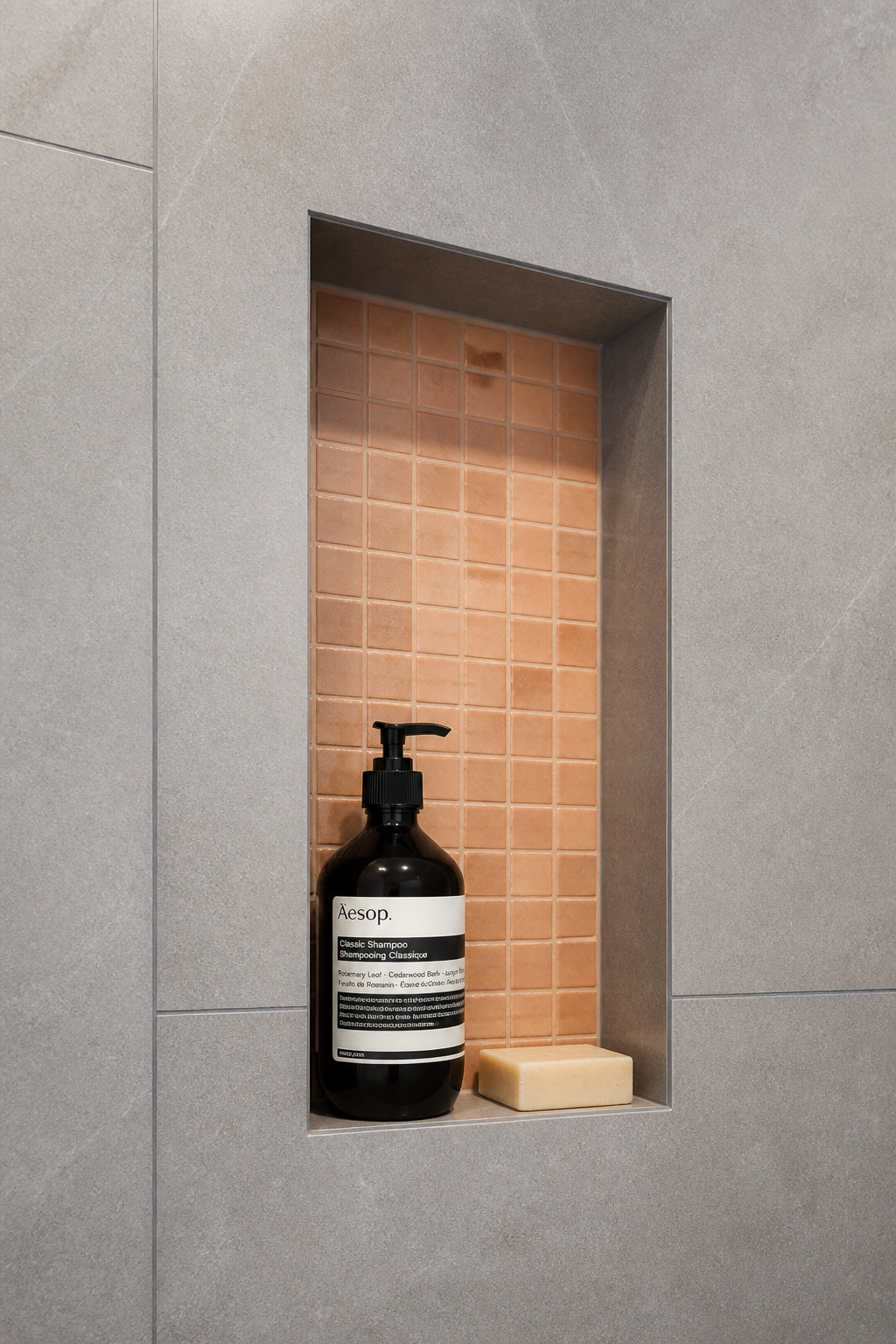 A 300x600mm tiled shower niche built into the wall before tiling — the detail that removes every bottle from the shower floor.