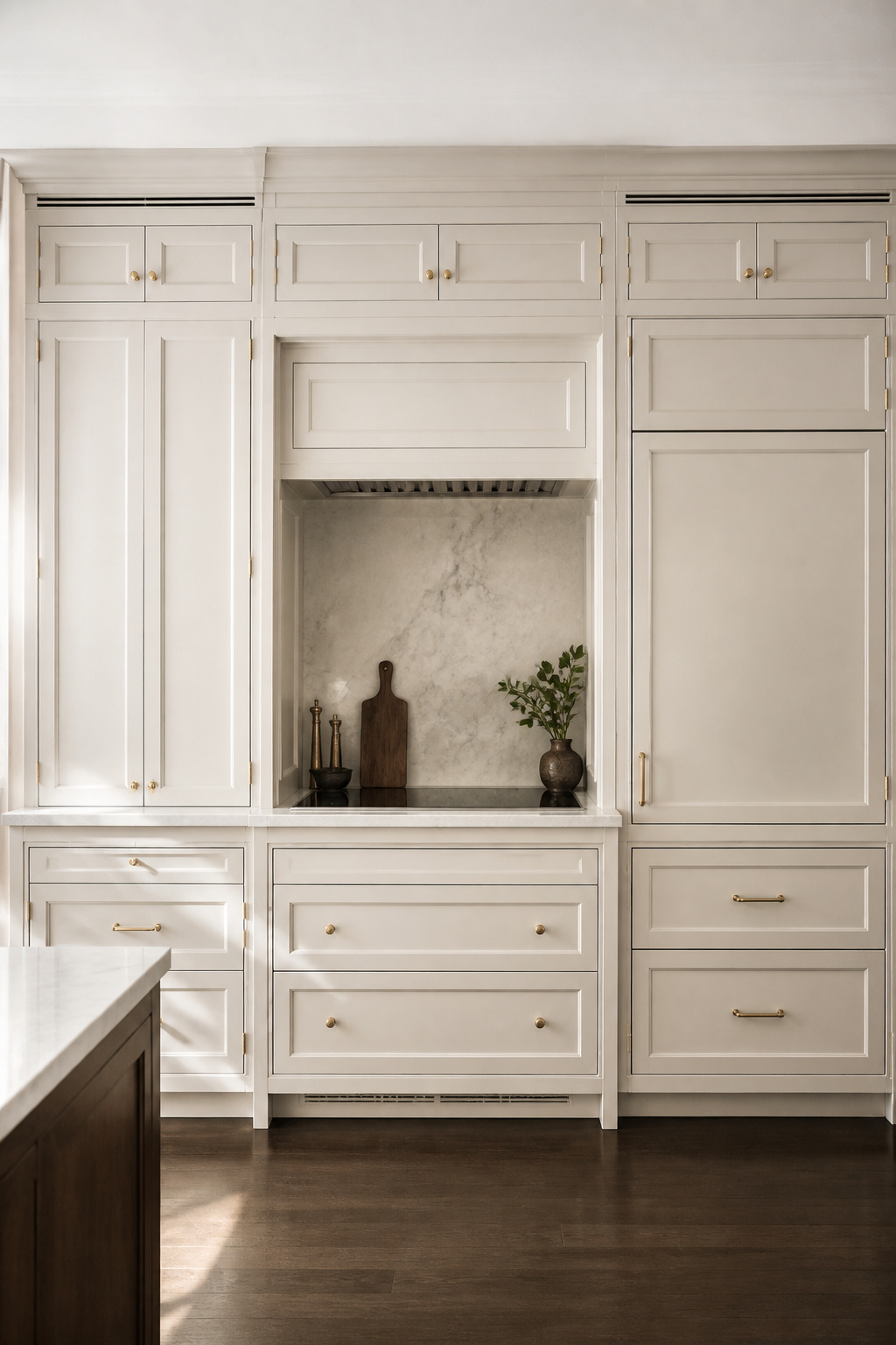 Panel-ready appliances disappear behind custom doors that match the surrounding cabinetry, the refrigerator column is indistinguishable from the cupboard beside it.
