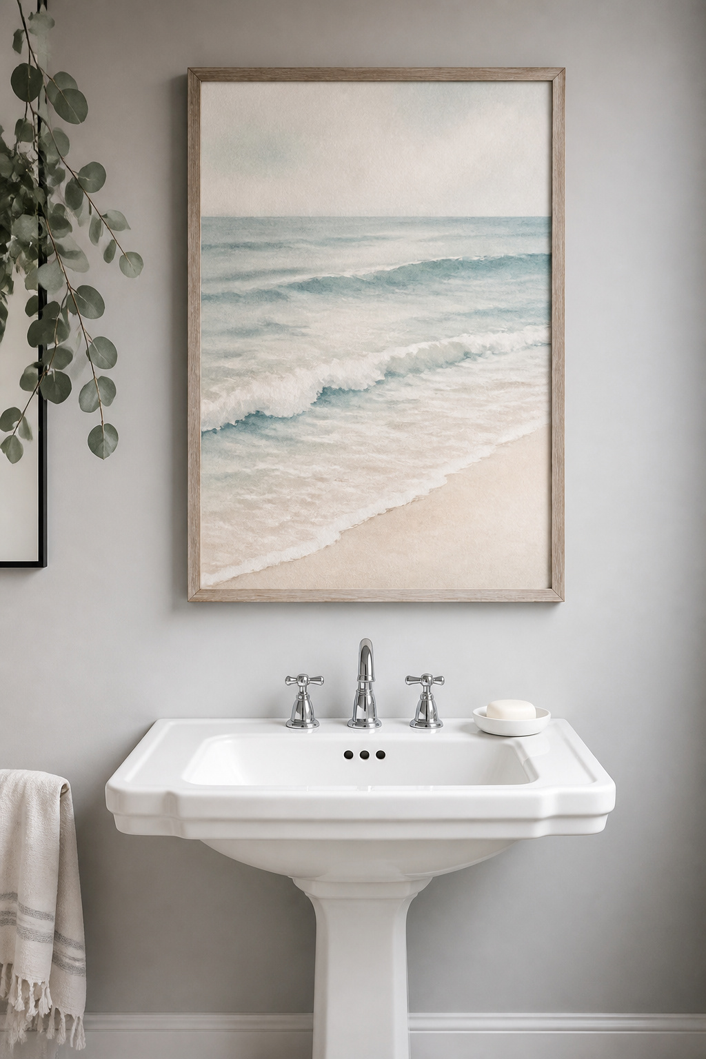 A single coastal watercolor in spa-toned blues and seafoam transforms a plain bathroom wall into a visual retreat — the muted palette amplifies the room's natural association with water.