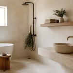 A serene Scandinavian bathroom combining limewash plaster, floating white oak shelving, a teak stool, and a travertine vessel basin in calm morning light.