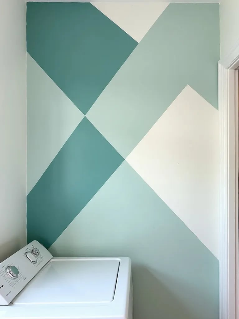 Laundry room with bold teal and white geometric accent wall