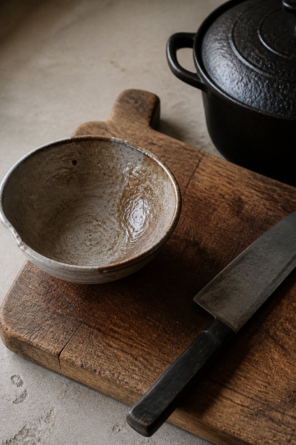 Handmade ceramics with uneven glazes, wooden boards showing knife marks, cast iron darkened by seasons of cooking — these wabi-sabi material choices find their beauty not despite imperfection but precisely because of it.