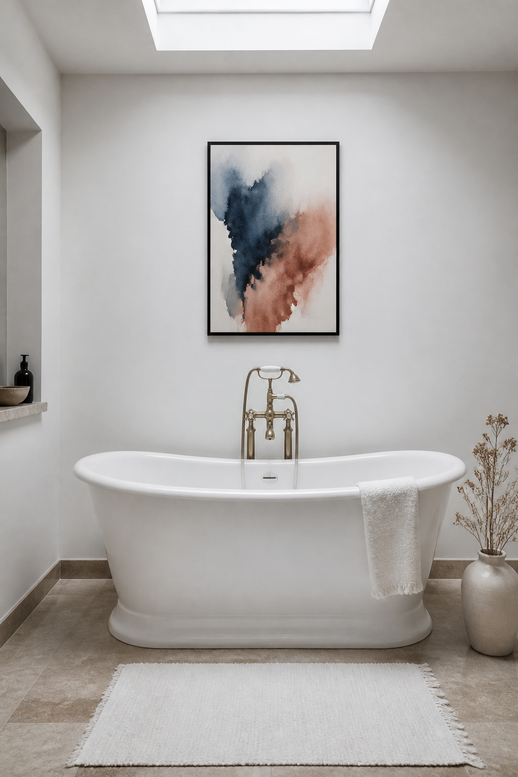 A single deep-indigo watercolour abstract above a freestanding tub does more work than any gallery wall in a bathroom of this scale — restrained, deliberate, and completely arresting.